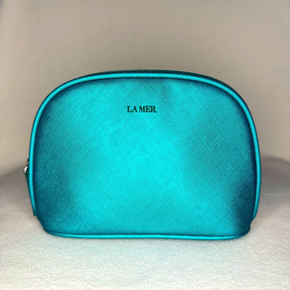 New La Mer Cosmetic Bag. Shiny blue-green color.